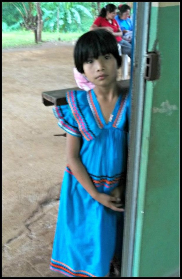 A local girl in typical handmade dress of colorful cloth.